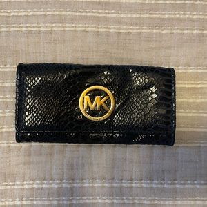 Blue snake skin and gold hardware Michael Kors wallet.